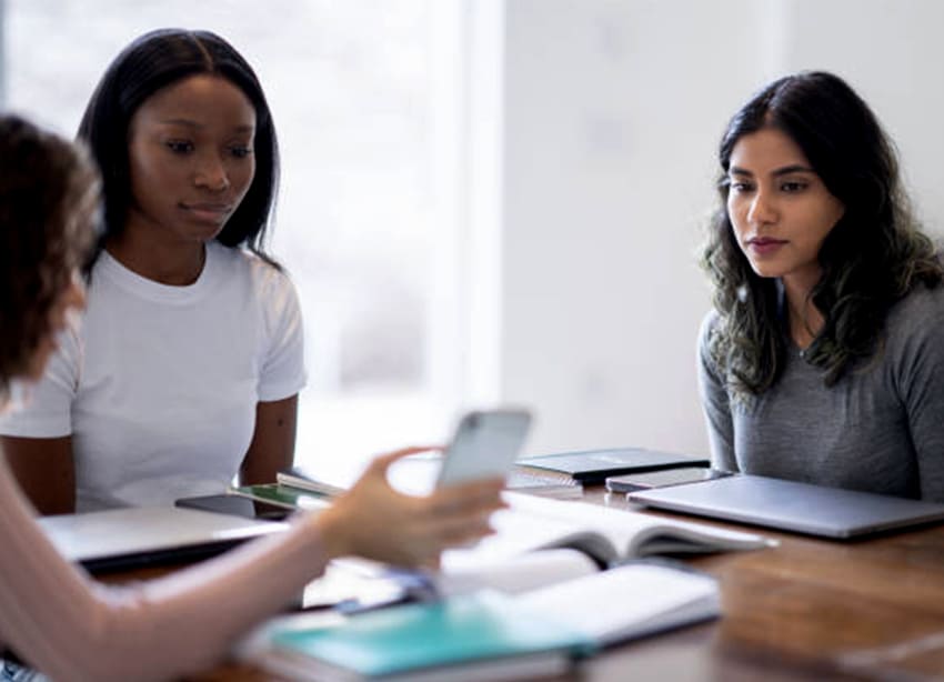 Diverse group of women discussing financial strategies in a study session, exploring investment and savings tips