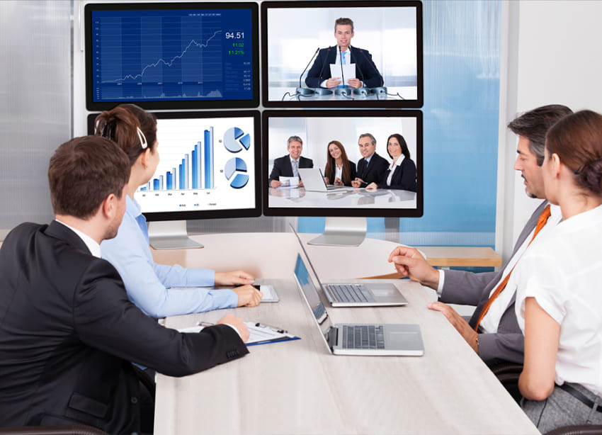 Virtual business meetings with multiple screens displaying graphs and charts, representing innovative business strategies